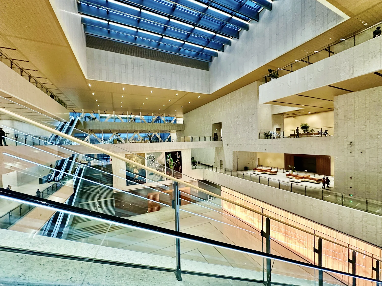 Multilevel atrium with stairs, escalators and glass railings