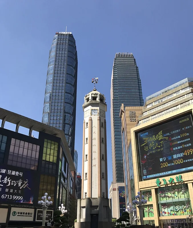 The Liberation Monument among Jiefangbei's commercial high-rises; an area illustration, not a hotel view.
